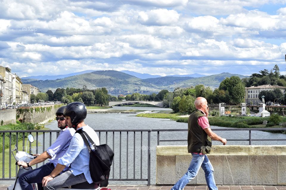 view from bridge across river Arno in Florence Italy