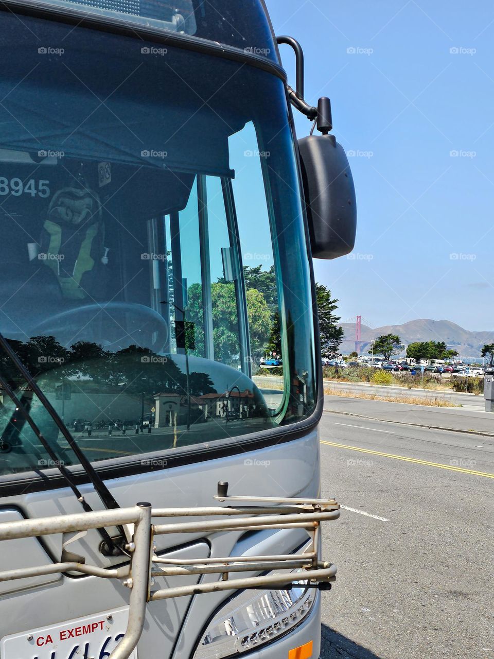 Public transportation bus on the city streets of San Francisco California with the Golden Gate Bridge and in the background 