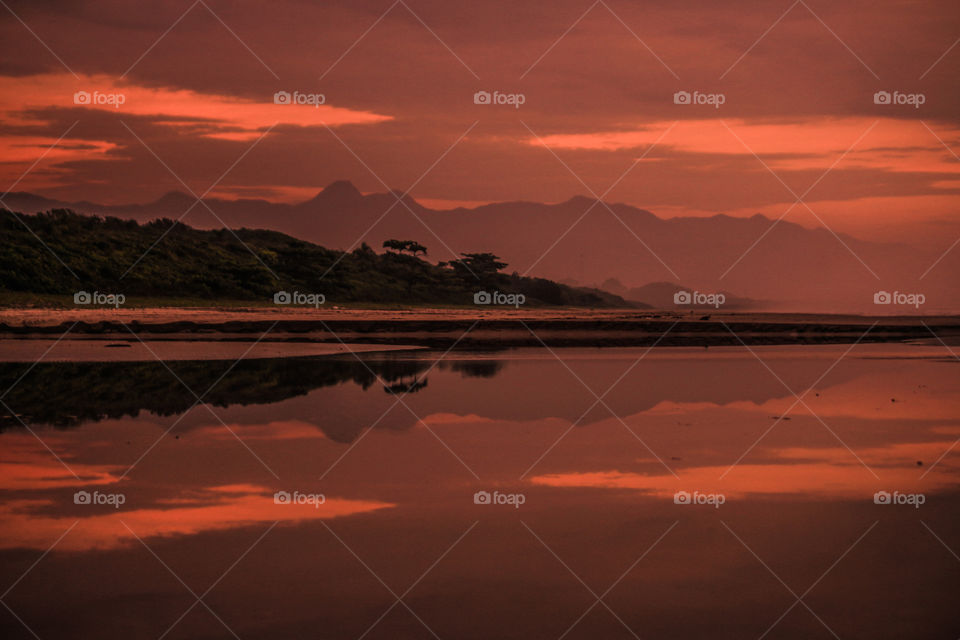 Reflection of mountain on lake during sunset