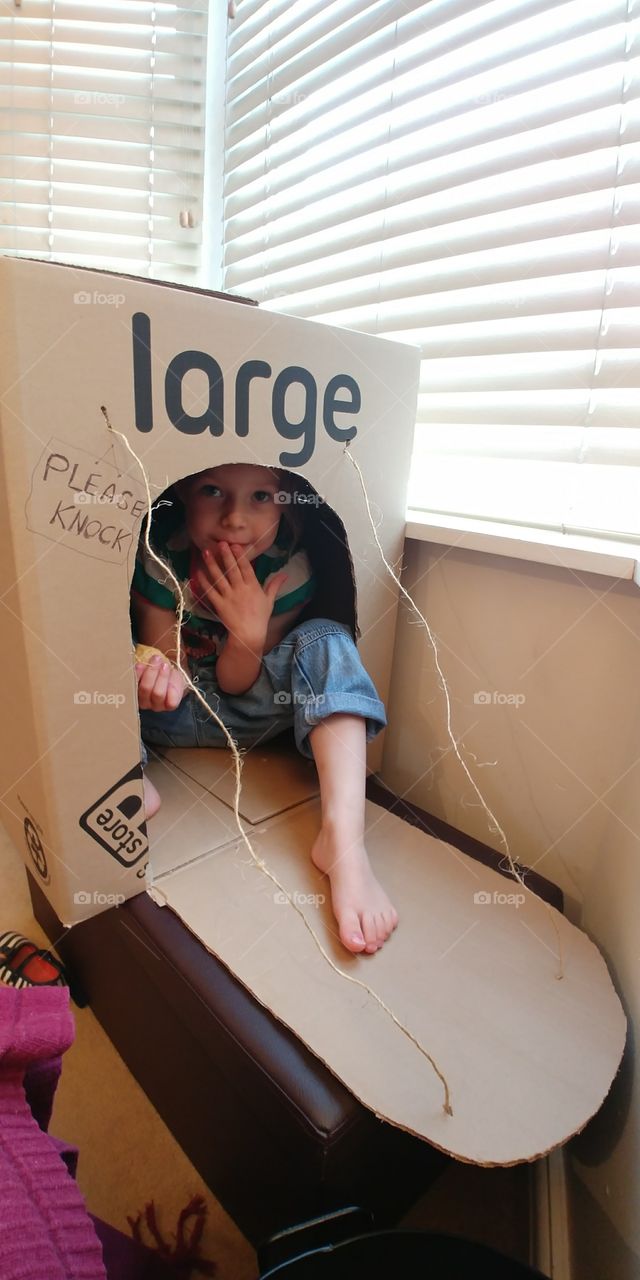 child in box fort