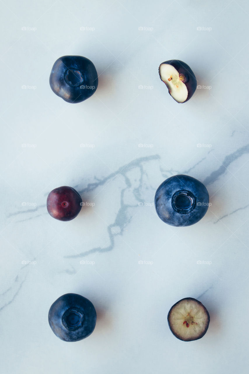 Flat lay fresh organic blueberries on a marble background 