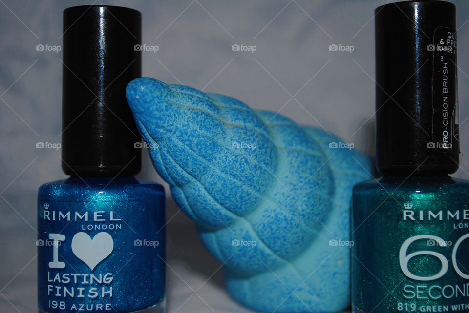 Rimmel London nail polish and a shell