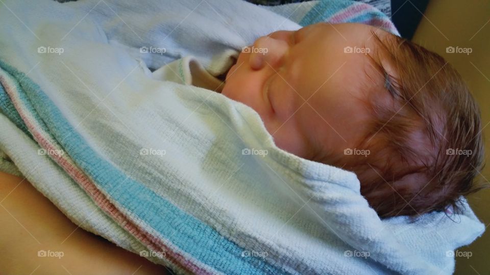 Newborn wrapped in hospital blanket