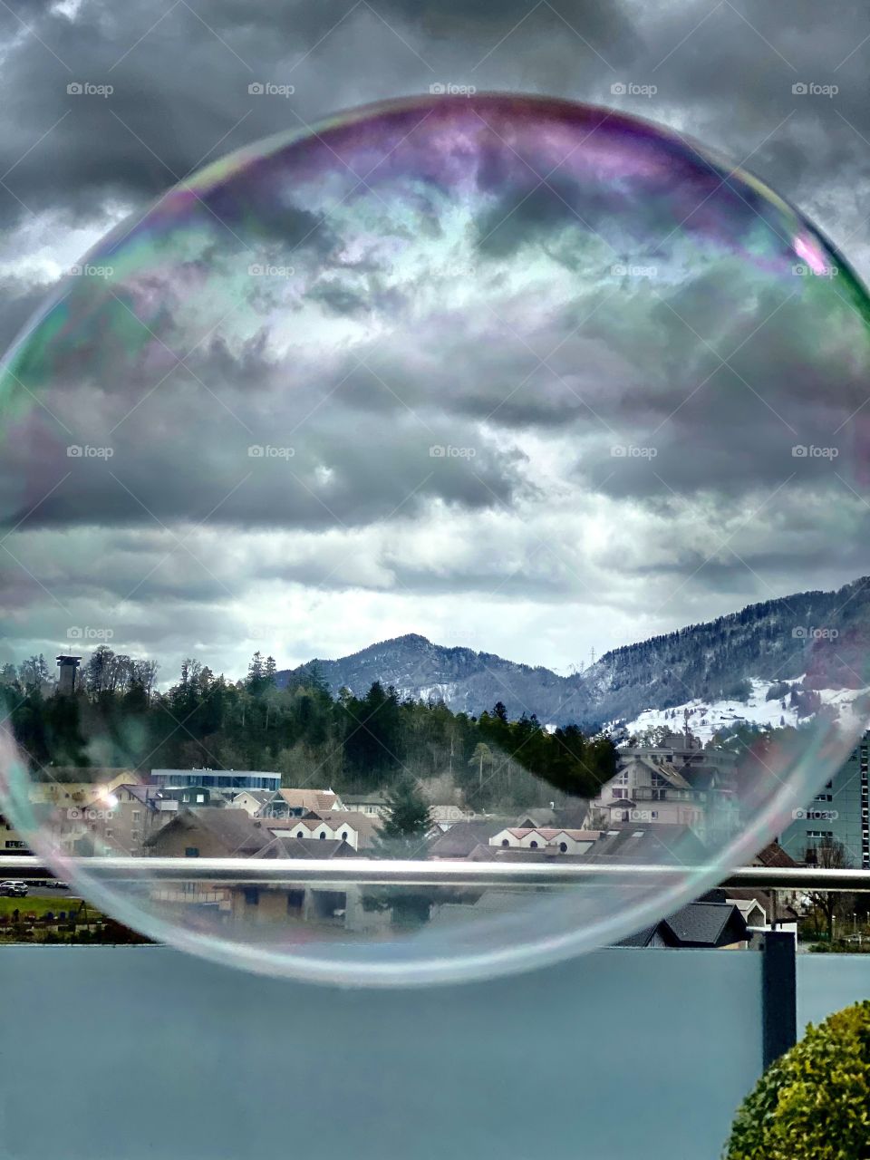 a large soap bubble flying in the air over the Swiss Alps