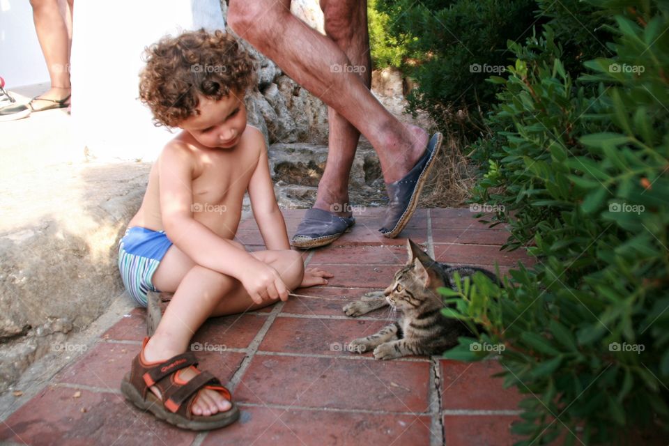 Boy and cat looking at each other