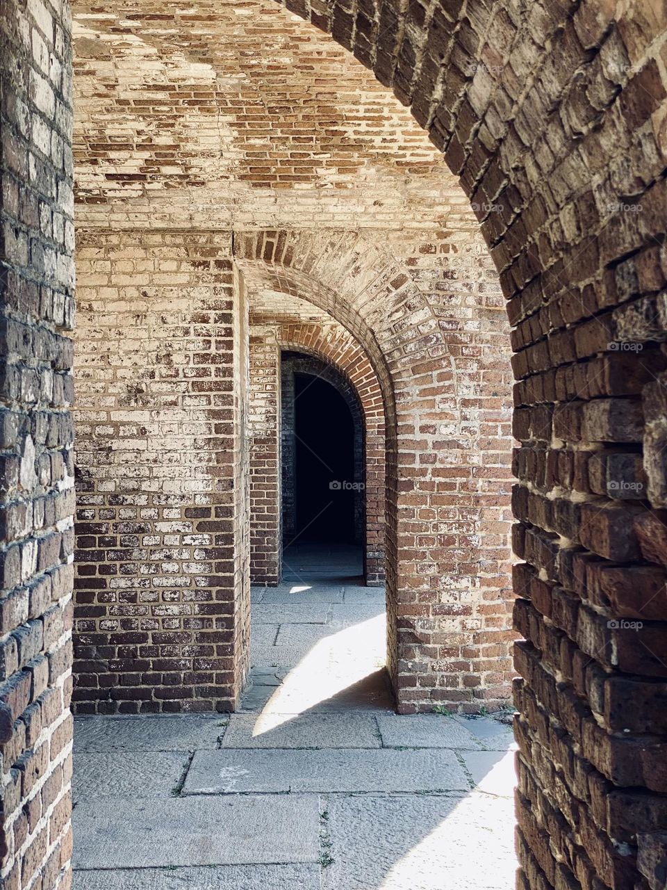 A series of archways in an old brick building