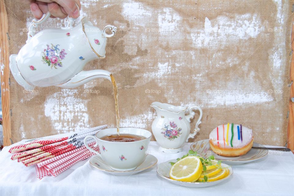 Tea being poured in cup