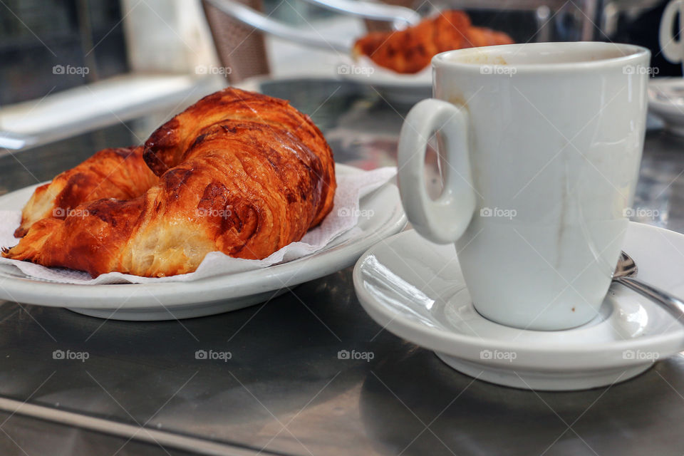 Delicious breakfast - coffee with croissant