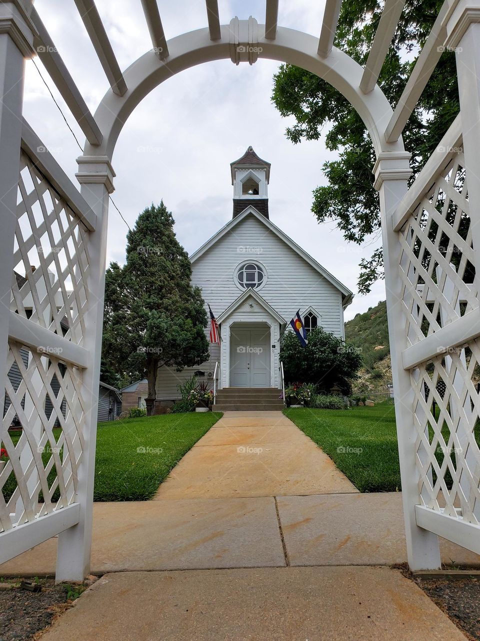 A beautiful small town chapel as seen from under the front arbor