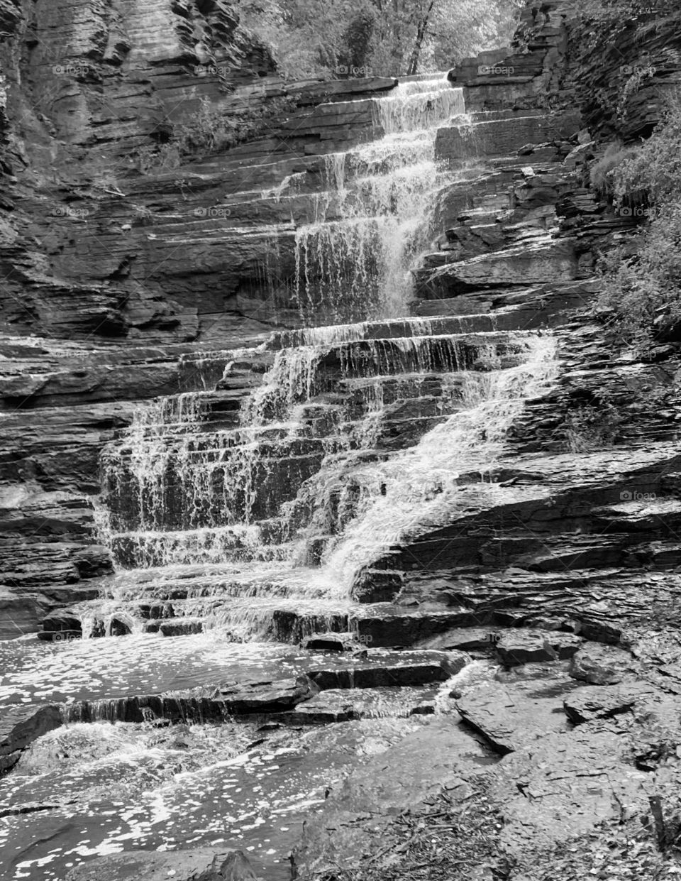 A beautiful black and white photo of a tall waterfall. Looks fantastic and is great to use. 