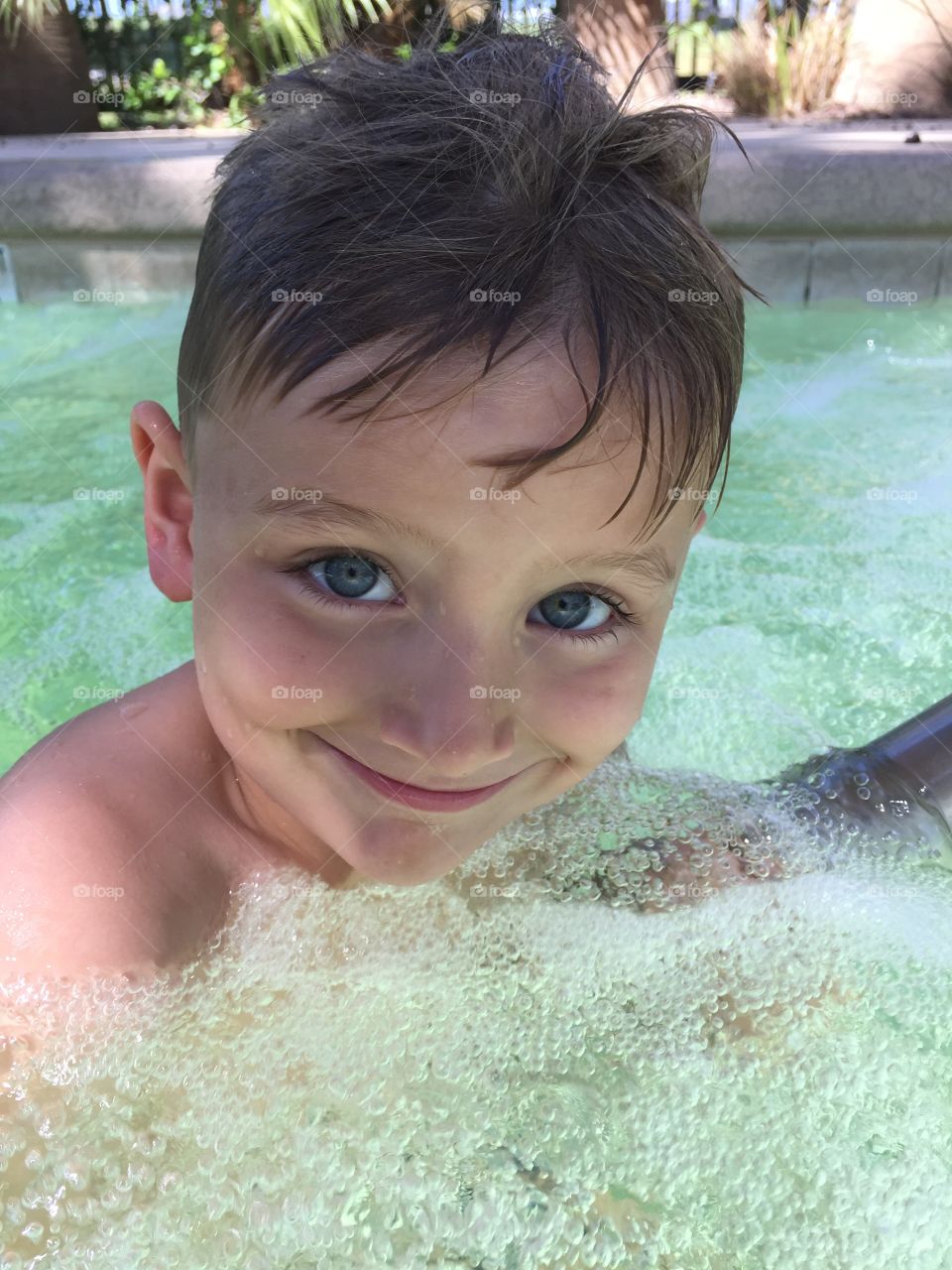 Happy boy swimming in pool