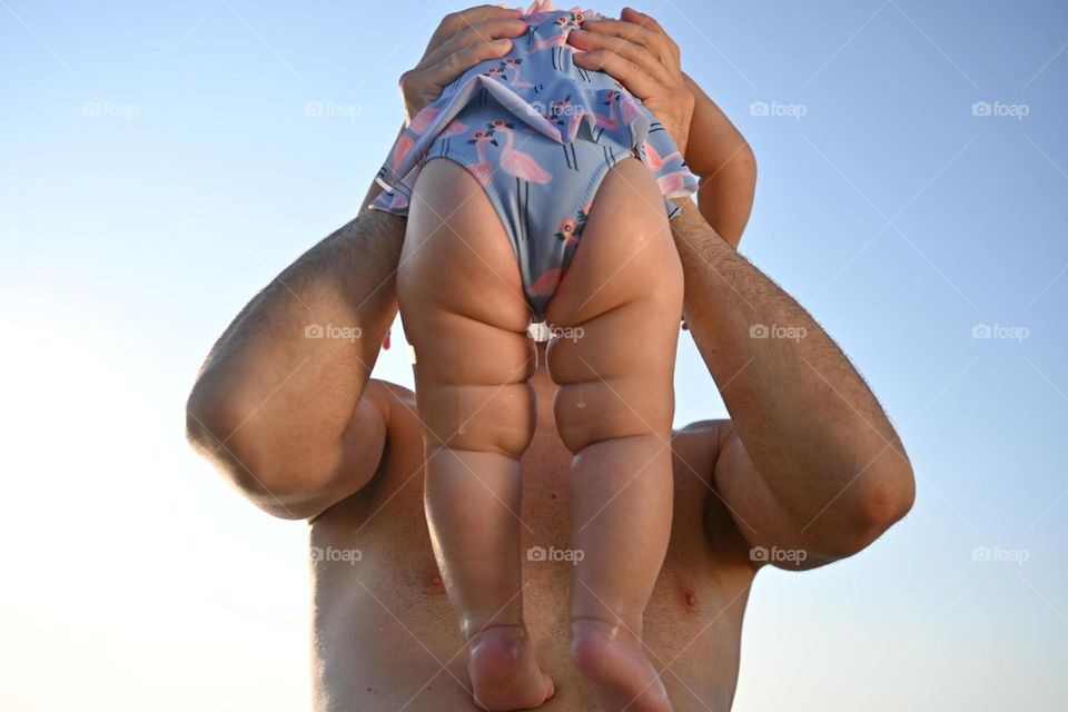 little girl flab rolls at the sea