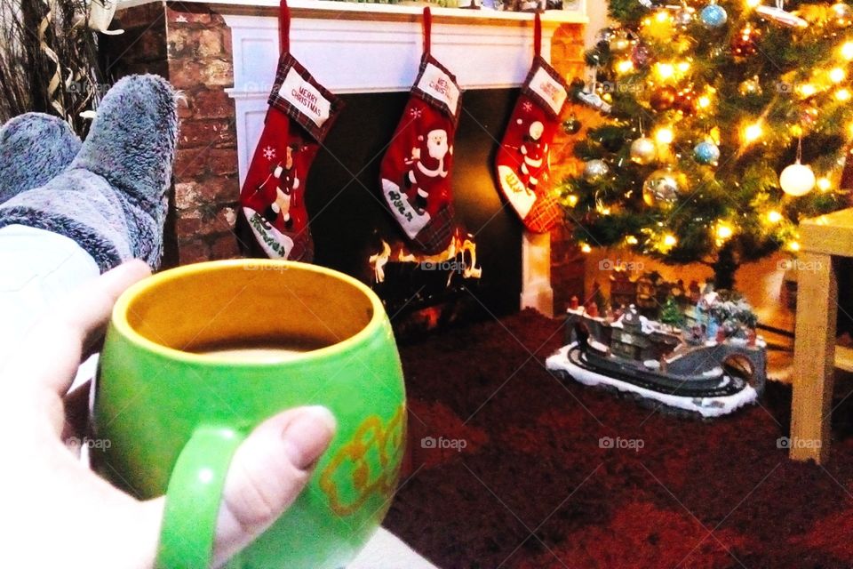 Christmas evening with a mug of tea wearing slippers