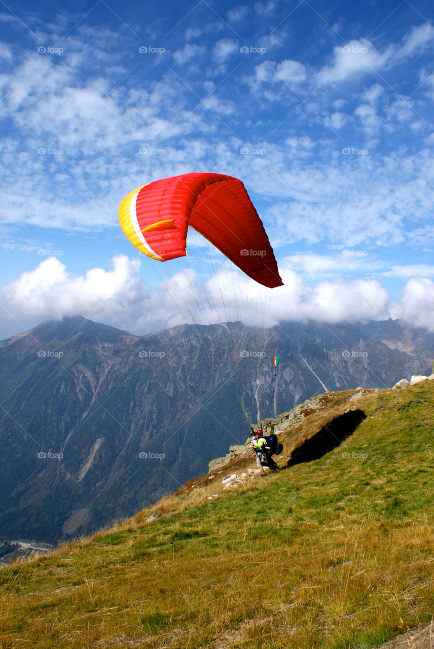 charmonix mountains. paraglider. blue skies. by snutten