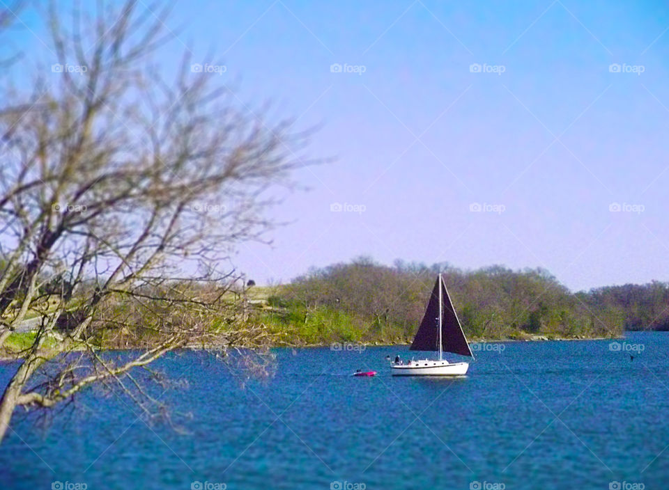 Boat on Lake, Blue Springs, Missouri. A beautiful day in Blue Springs as a small boat glides across the water.