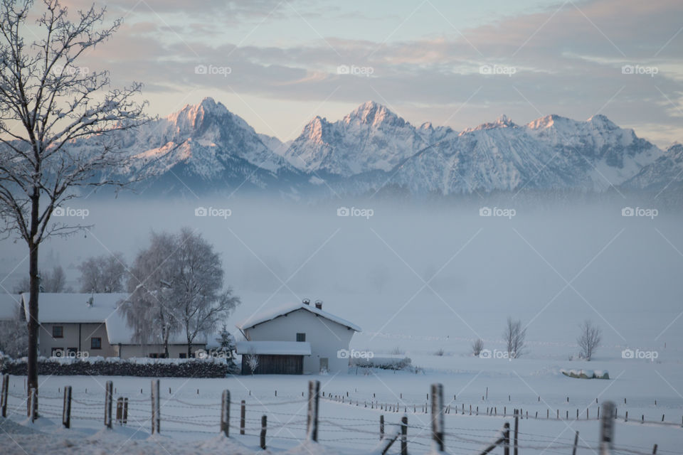 A foggy village in the Alps