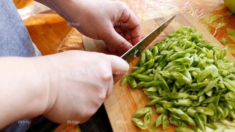 Close-up of a person cutting vegetable