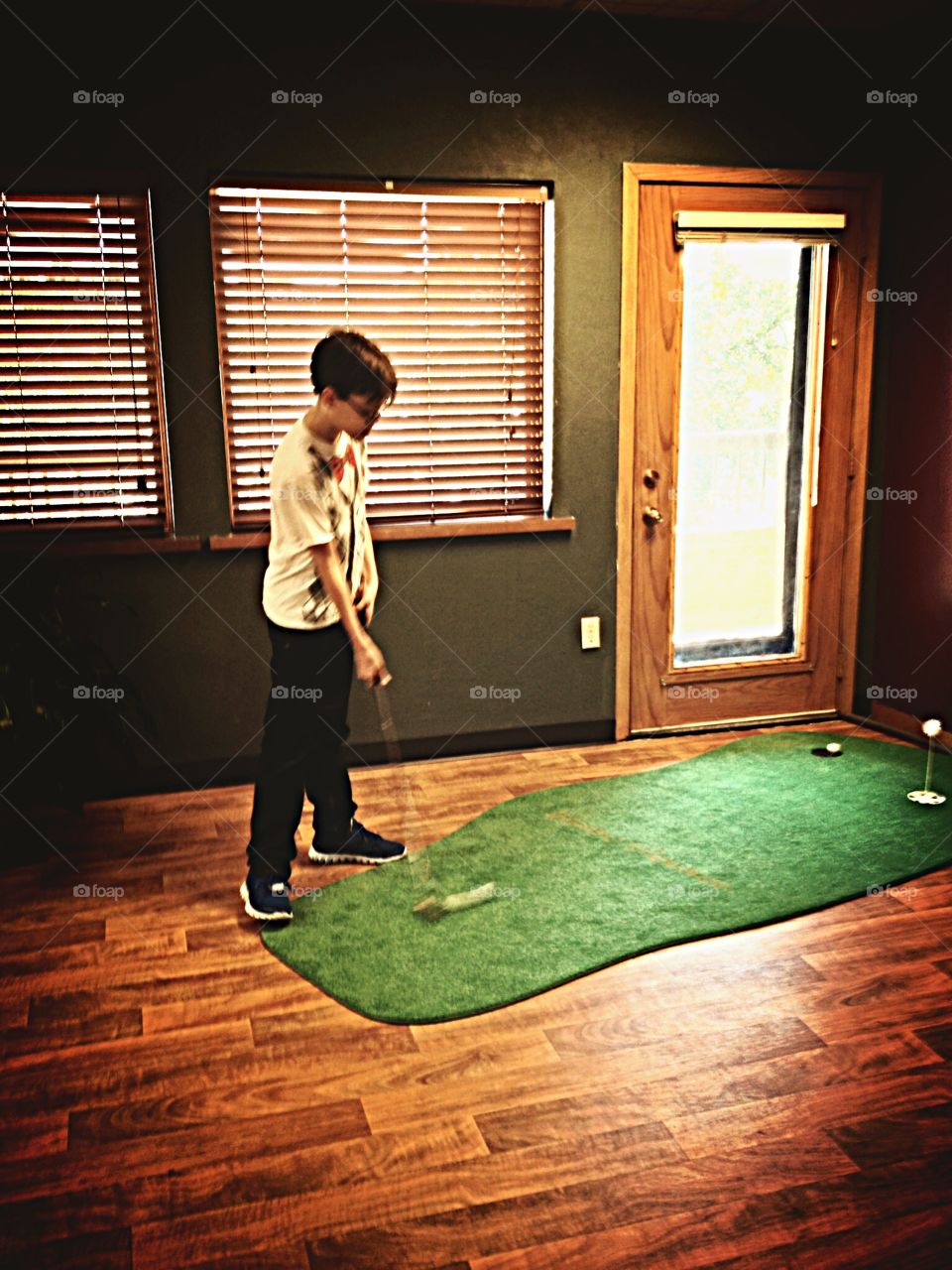 Putting practice while waiting for the eye doctor. 
