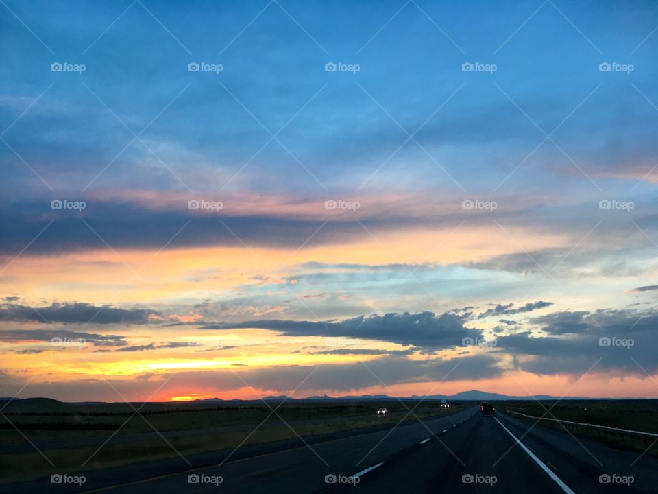 Stunning sunset over the mountains while driving through Wyoming. 