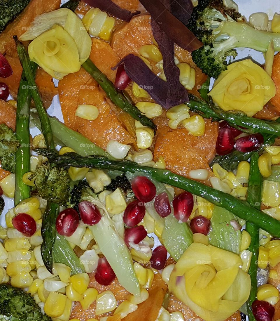 Oven roasted harvest veggies with vegetable flowers and pomegranate arils