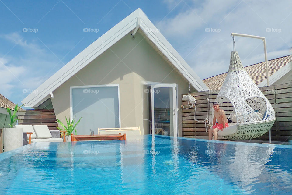 Relaxing by the pool outside of a house 