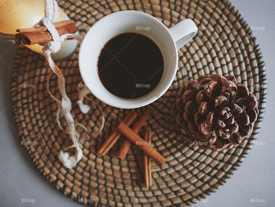 High angle view of coffee cup with pine cone