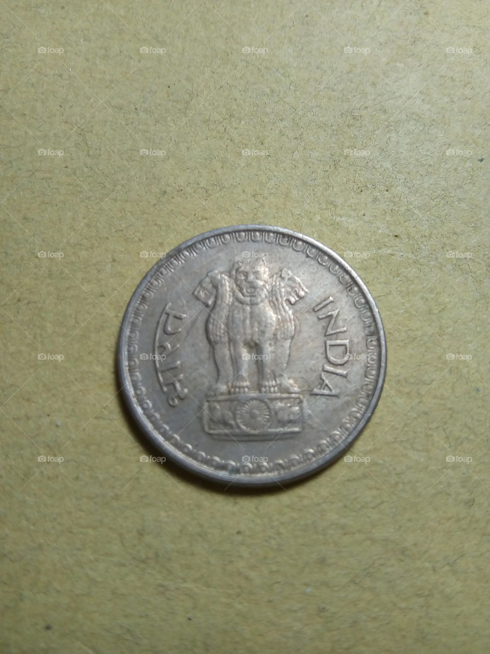 A coin of Twenty five paise- 1/4 share of Indian Rupee issued by Government of India in 1988.