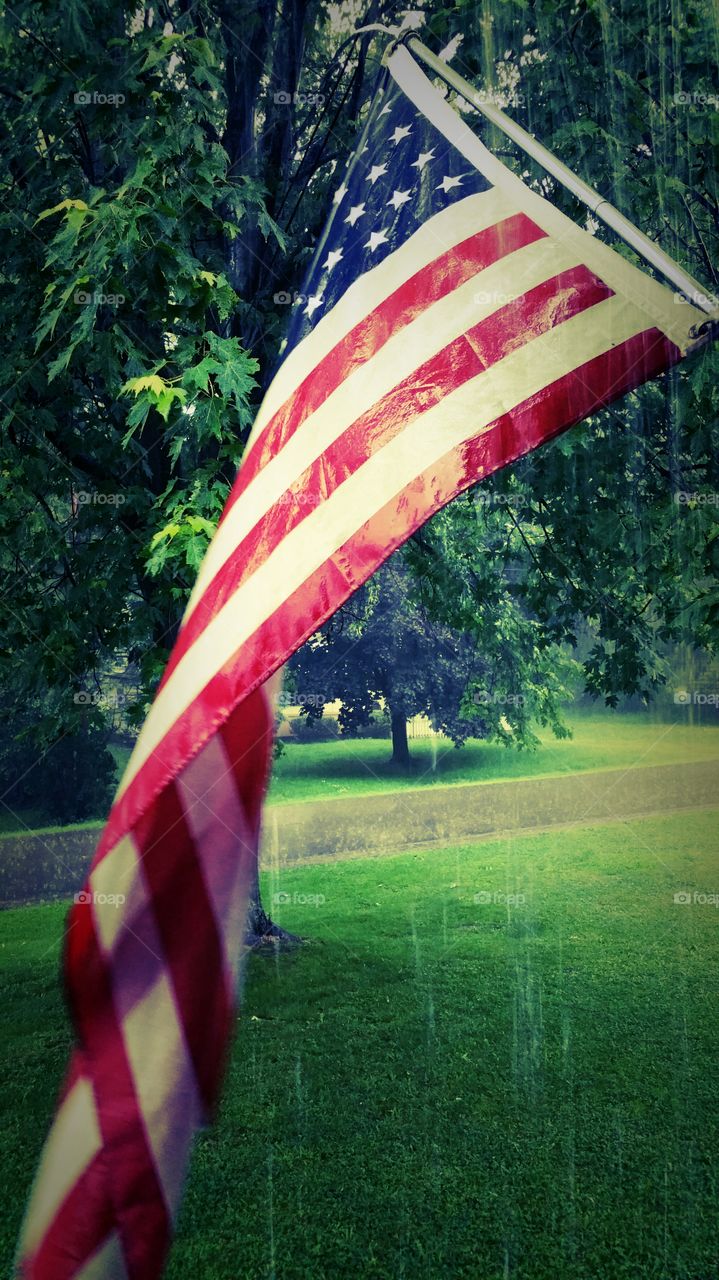 pouring rain on American flag. pouring down rain outside