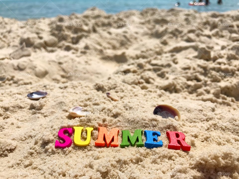 The word summer on the sand
