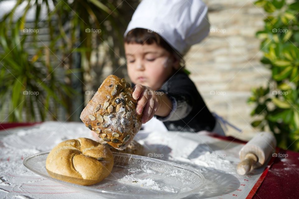 little girl chef preparing bread