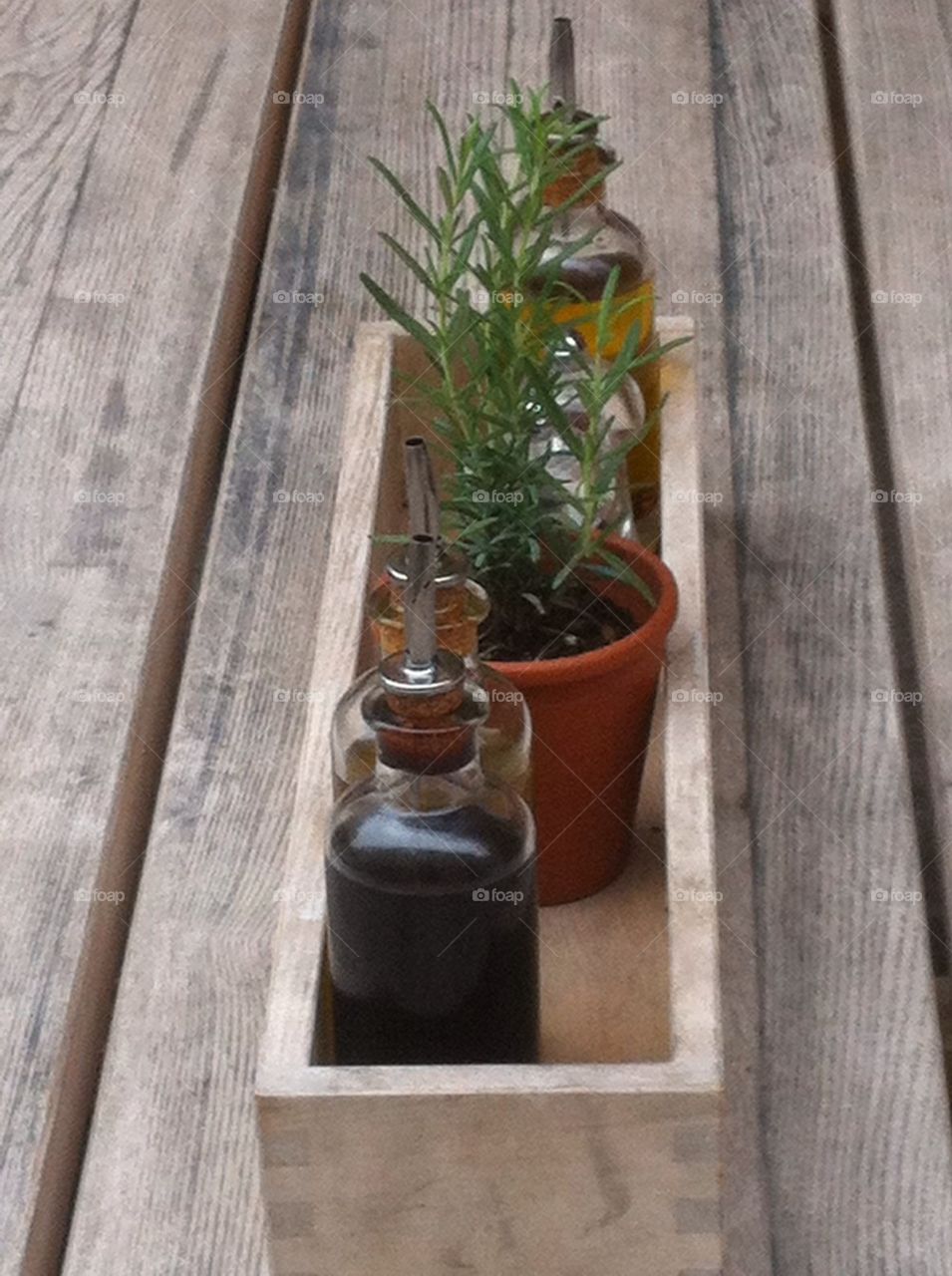 Rustic restaurant table with olive oil, balsamic vinegar and rosemary