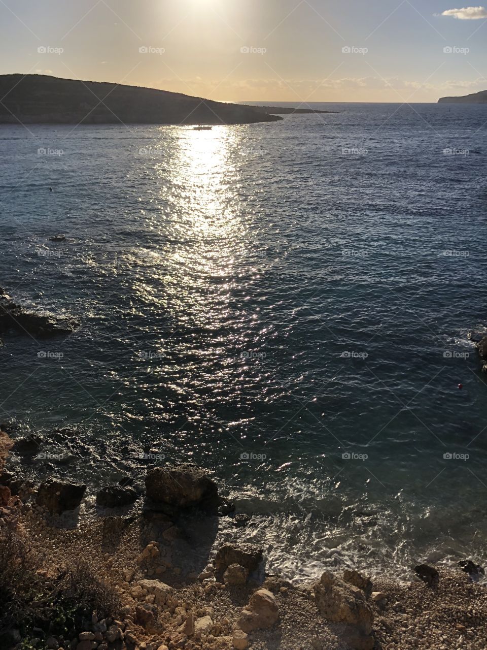 A striking sunset view from the hillside overlooking the gorgeous Blue Lagoon in Comino, Malta. 