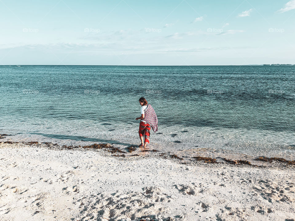 lady strolling along the shore