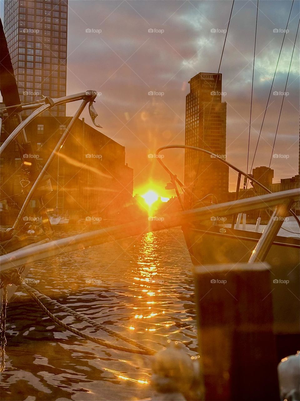 This glowing fireball is the sun setting over “Newtown Creek” by the “Pulaski Bridge” in LIC, Queens seen from “Salvation”, the “28 foot 1969 Luhrs” cabin cruiser that I and my longtime partner “Timothy Trespas” call home. 2024. Hypnotic Productions