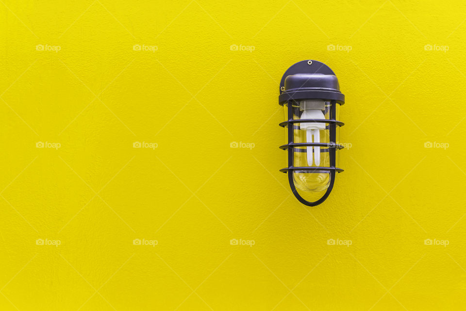 Classic lamp on yellow wall background