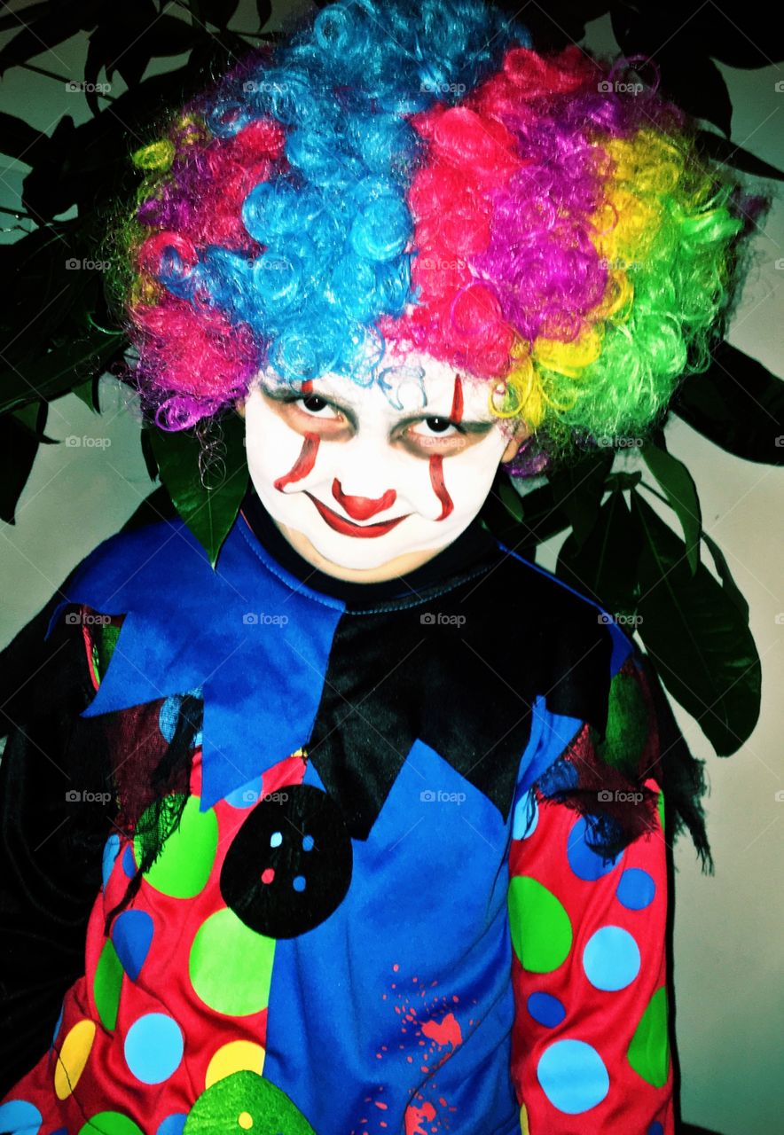 Creepy kid dressed as a clown