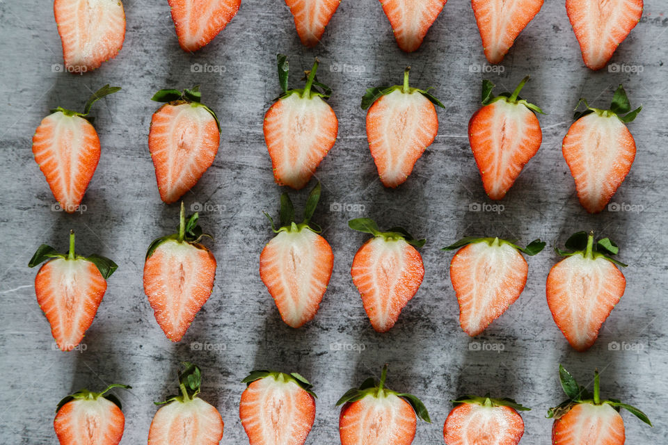 Fresh strawberry lying on gray background 