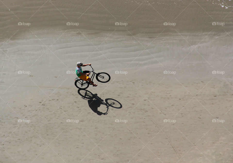 Putting the bike on the beach and making shade.