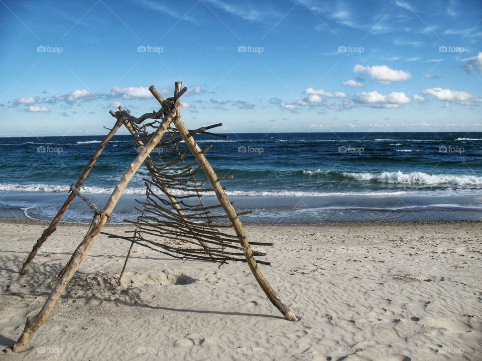 construction of branches on the beach конструкция из веток на пляже