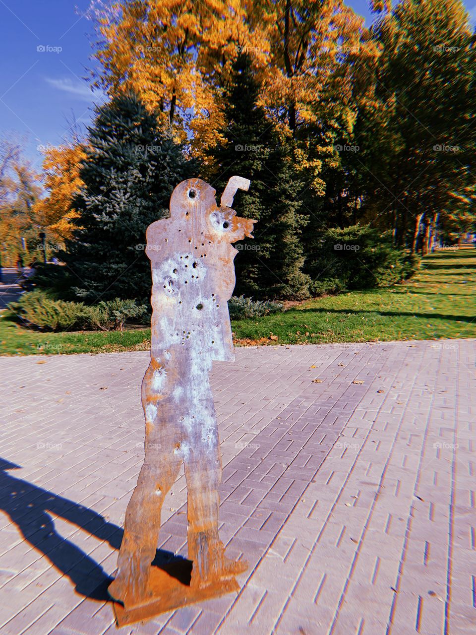 War photographer installation at street with shadow 