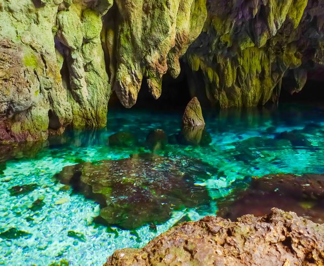 The enchantment of a mystical stone in the blue water in Hawang Cave