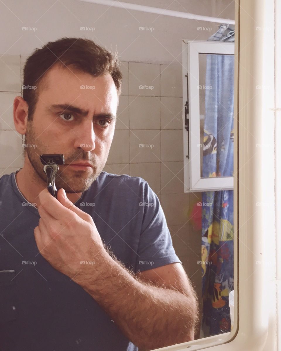 Serious man ready to shave his beard