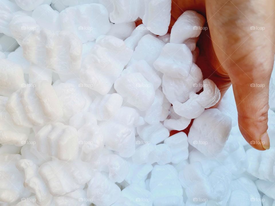 hand sinks into styrofoam petals for packing