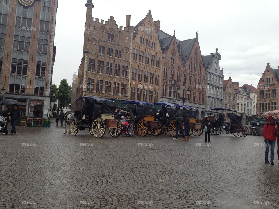 Horses in Bruges. Horse drawn carriages in the main square in Bruges, Belgium.