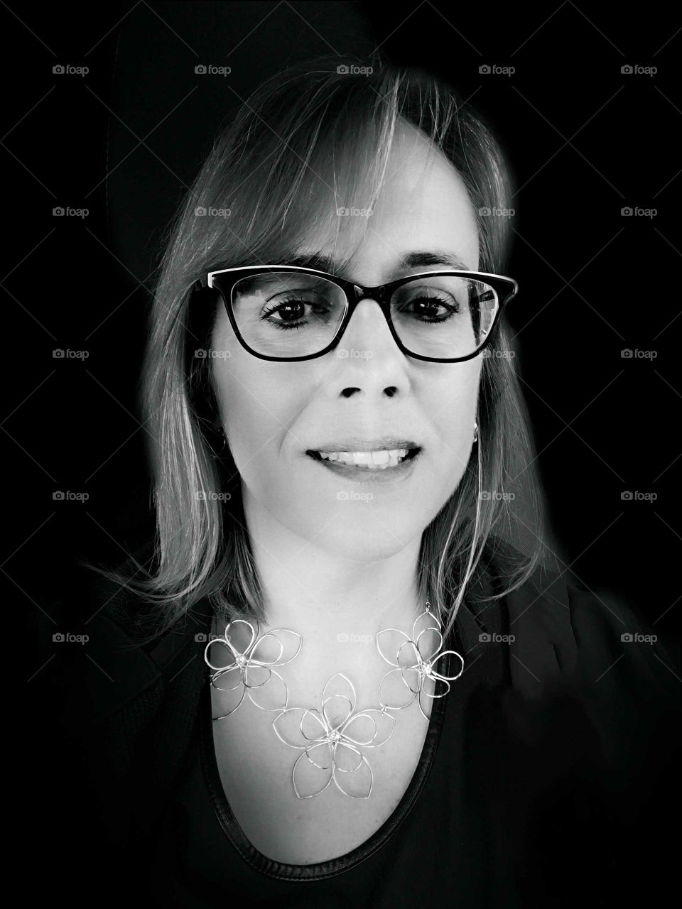 a girl with eyeglasses smiling