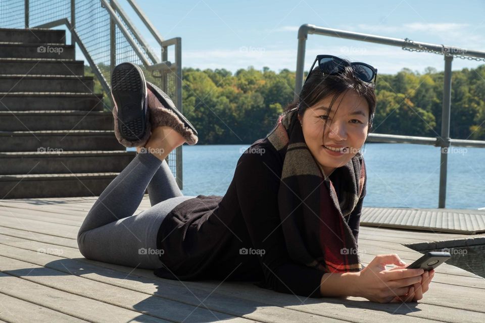 A young lady of Taiwanese is showing off her comfy slippers. 