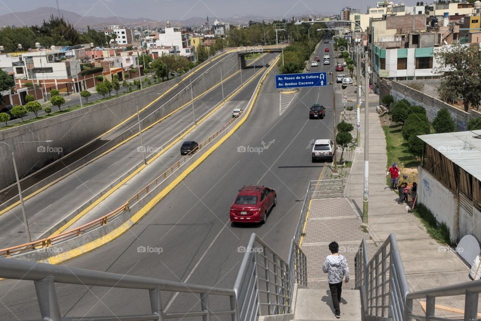 Young man looking out from a highway in the city