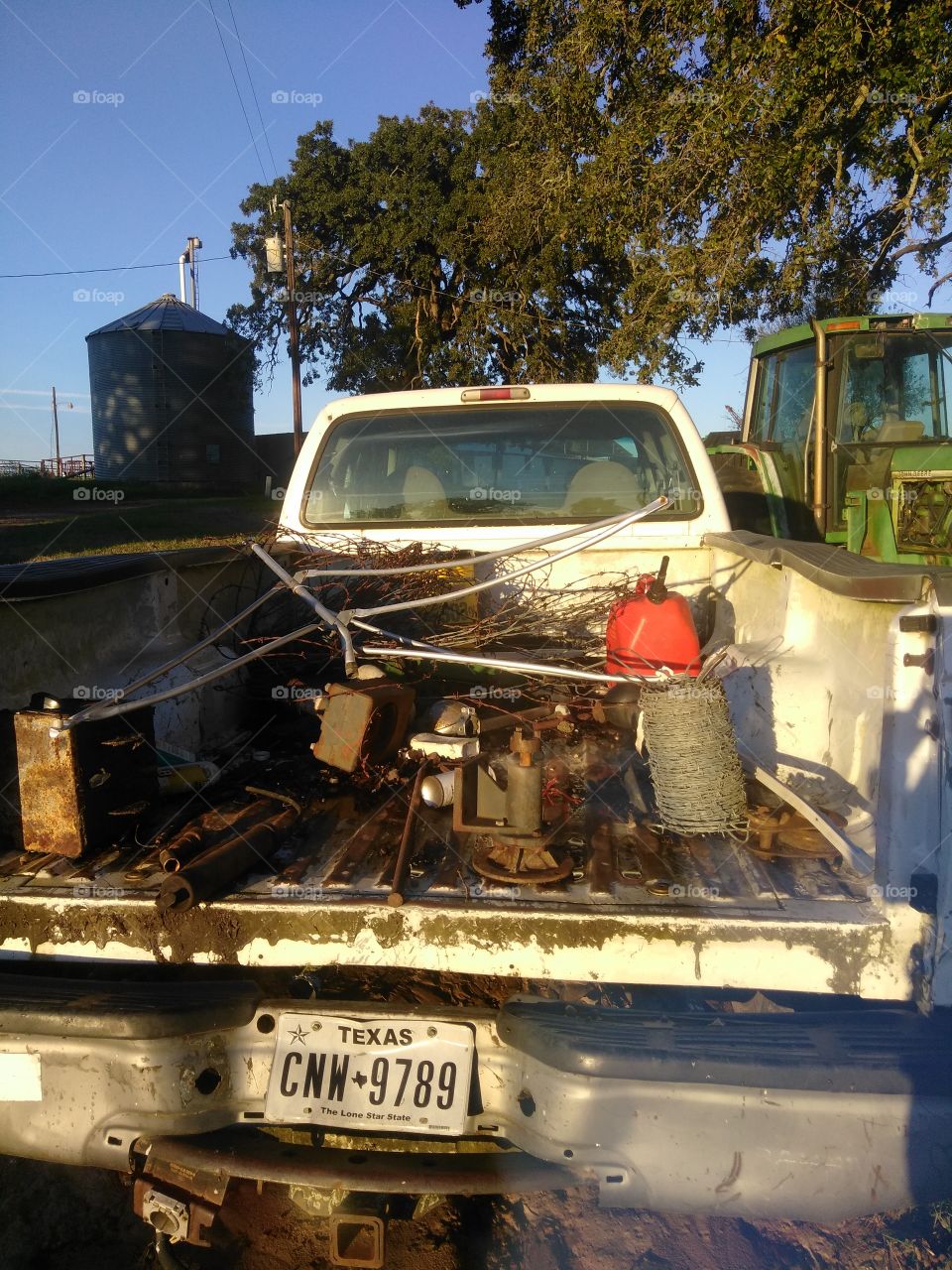 Ford F-250 power stroke with fencing and tools in back