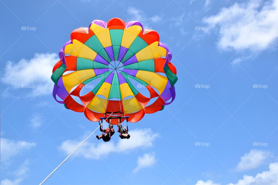 Couple flying with parasail