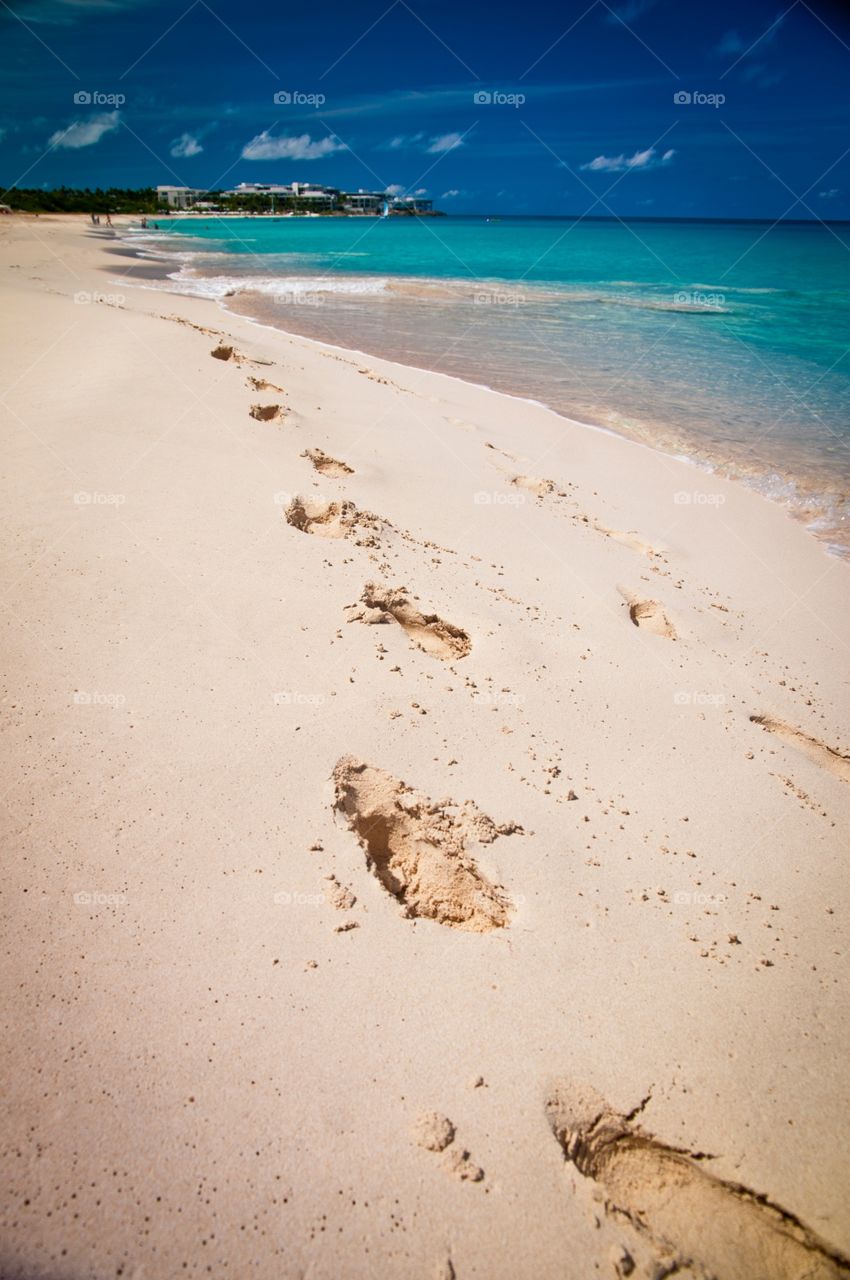Sandy footprints down the beach in Anguilla 
